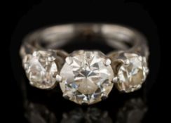 A diamond mounted three-stone ring: with round old European, brilliant-cut stones approximately 5.