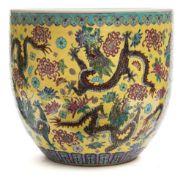 A Chinese famille rose porcelain jardiniere: the exterior brightly painted with nine dragons