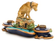 A Minton majolica desk stand: in the form of seated hound with a bowl at foot,