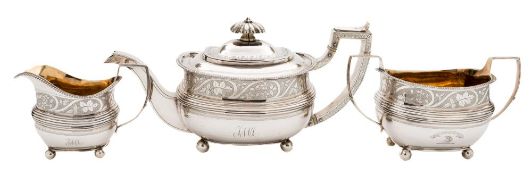 A George III silver three-piece tea service, maker's marks worn, London, 1814: crested,