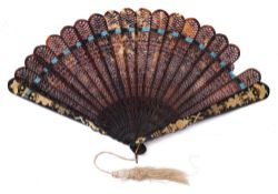 A 19th century Chinese tortoiseshell brise fan: with pierced leaves and gilt decorated solid guards,