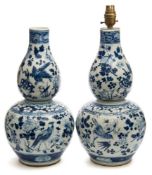 A pair of Chinese blue and white porcelain double gourd vases: painted with birds amongst blooms