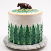 A Minton majolica stilton cover on a grey marble base: the cover of cylinder form and moulded with