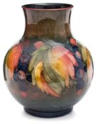 A Moorcroft pottery flambé ground vase: of oviform with raised neck tubelined in the Leaf and Fruit
