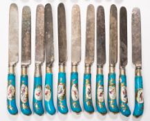 A group of French porcelain pistol handled cutlery: comprising of eleven knives and ten forks with