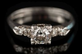 An illusion-set diamond ring: the central circular, brilliant-cut diamond estimated to weigh 0.
