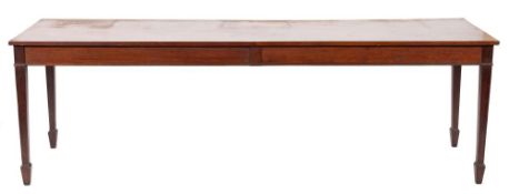 An Edwardian mahogany rectangular serving table:, on square tapered legs, terminating in spade feet,
