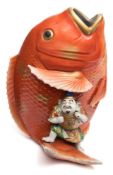 An Arita porcelain 'leaping carp' vase: modelled with a large fish with a small male figure