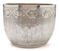 An Indian silver bowl : the side with reeded decoration and band of panels decorated with assorted