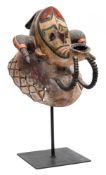 Gabon, a Fang tribal mask: the face with painted polychrome decoration, extended mouth,