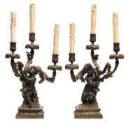 After Clodion - a pair of 19th century parcel gilt and bronze candelabra:,