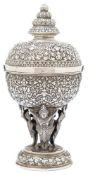 A Burmese silver bowl and cover: the domed lift-off cover with lotus flower finial, having scroll,