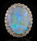 An 18ct gold, opal and diamond claw-set oval cluster ring: the oval opal 19.9mm long x 15.