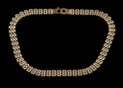 A two-colour 9ct gold necklace:, 44.4cm long, 31.5gms gross weight.