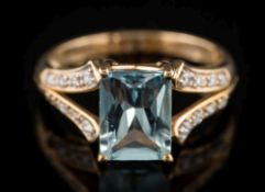 An aquamarine and diamond ring: the rectangular aquamarine 8.9mm long x 6.