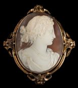 A late 19th century oval shell cameo portrait brooch: the oval shell cameo 54mm long x 41mm wide