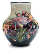 A Moorcroft pottery vase: of oviform with raised neck tubelined in the Spring Flowers pattern in