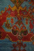 A Turkish carpet:, of large size, the pastel blue field with all over cruciform,