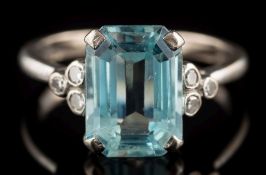 A white gold, aquamarine and diamond ring: the central rectangular aquamarine 10.8mm long x 7.