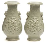 A pair of Chinese celadon-glazed porcelain vases: with lion dog mask ring handles,