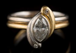 A marquise-cut diamond mounted two-tone cross over ring: of stylised 'Ying and Yang' design,