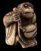 Two Japanese carved bone netsuke: the first depicting Songoku [the Monkey King from the 'Journey to