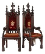 A pair of Victorian Gothic carved oak Armchairs in the manner of Pugin:,