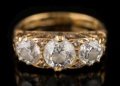 A late 19th century gold and diamond mounted three-stone ring: with graduated round old