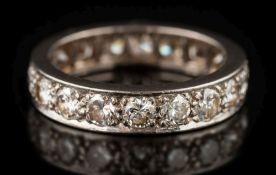 A diamond mounted eternity ring: pave-set with eighteen circular,