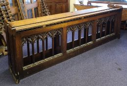 A pair of early 20th century carved oak pew fronts in the Gothic style:, 277cm long x 90cm high.