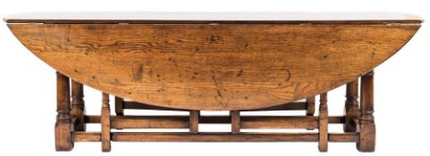 An oak oval double action gateleg table of large size:, in the 18th Century taste,
