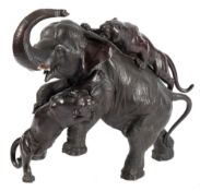 A large and impressive Japanese bronze group of a trumpeting elephant being attacked by two tigers,
