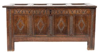 An early 18th Century oak carved rectangular coffer:, with a plain hinged moulded panel top,