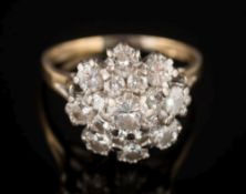 An 18ct gold, platinum and diamond circular cluster ring: with graduated,
