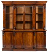 A Victorian mahogany breakfront library bookcase:, the upper part with a moulded cornice,