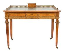 A Victorian satinwood and gilt brass mounted writing table:,