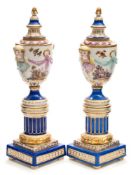 A pair of Berlin porcelain cassolettes: each of vase shaped form painted with figures in a