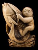 A Japanese carved ivory okimono and a netsuke: the first depicting Kinko riding on the back of a