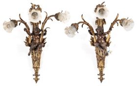A pair of 19th century French bronze and gilt metal three branch wall lights: the ribbon tied back