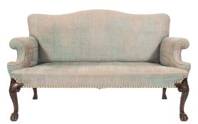 A carved mahogany settee in the George II taste:, with an upholstered stuff over serpentine back,