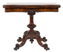 A Victorian carved walnut card table:, of serpentine outline,