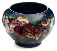 Two Moorcroft pottery vases: tubelined in yellow, blue, red, purple,
