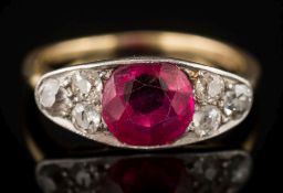 A synthetic ruby and diamond seven-stone cluster ring: the circular synthetic ruby approximately 7.