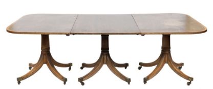 A mahogany and inlaid three pillar dining table in the Regency taste:,