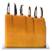 An Art Deco period bakelite and chrome cocktail stick stand: modelled as six penguins standing on