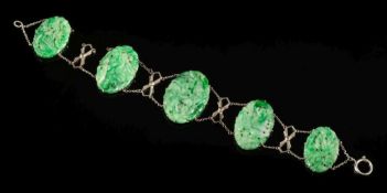 A carved and pierced jade oval panel-link bracelet: the largest panel 30mm long x 20mm wide and on