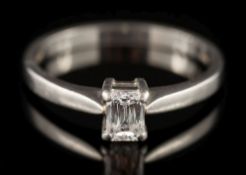 A platinum and baguette-cut diamond solitaire ring: the baguette-cut diamond 4.9mm long x 3.