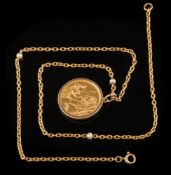 A sovereign dated '1958' within a 9ct gold mounted pendant frame:, on an 18ct gold,