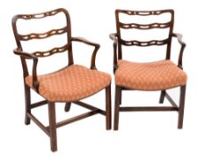 Two similar George III mahogany ladderback elbow chairs:,