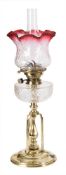 An Arts & Crafts influence brass oil lamp: with Hicks No 2 Lever wick holder,